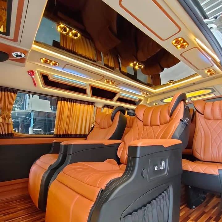 ภายในรถตู้ VIP เบาะหนังส้ม ไฟเพดาน ผ้าม่าน และพื้นไม้